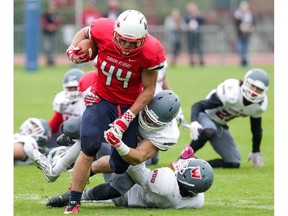 Simon Fraser running back Ante Litre powers his way through a pack of Western Oregon Wolves during GNAC play last season at Swangard Stadium. Litre and the Clan, coming off a winless 2015, open play Saturday on the road against Idaho State. (Ron Hole/SFU athletics) [PNG Merlin Archive]