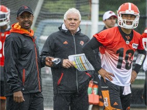 B.C. Lions offensive co-ordinator Khari Jones (left) and head coach Wally Buono (centre) haven’t kept the reins on young quarterback Jonathon Jennings (right), who has taken chances — and largely succeeded with his decisions — so far this season.