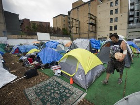 A tent city continues to stay active ( across from 43 Hastings Street) in downtown Vancouver.