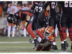 B.C. Lions defensive lineman Alex Bazzie takes down Redblacks quarterback Trevor Harris last week in Ottawa. Bazzie has a league-leading eight sacks so far this season.