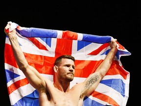 Michael 'The Count' Bisping of England flies the Union Jack flag in London on February 26, 2016.