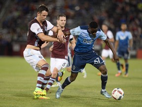 Vancouver Whitecaps midfielder Alphonso Davies battles with Colorado Rapids defender Bobby Burling for control of the ball in the second half of the match at Dick's Sporting Goods Park. The Rapids defeated the Whitecaps 2-0.