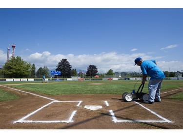 A groundskeeper prepares the field for the Opening ceremonies for the Canadian Little League Championship