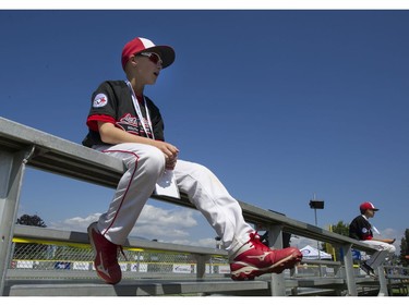 Alberta Little league player Aidan Lazenby waits on the bleachers after playing his first game at the Canadian Little League Championship.