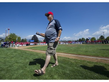 Richard Saunders walks off the field with his plaque after the field was named after The Richard Saunders Field at the Opening ceremonies for the Canadian Little League Championship
