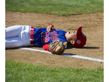 Whalley Little League #12 James Tang lays beside first base after a Moose Jaw Little League player collided with him