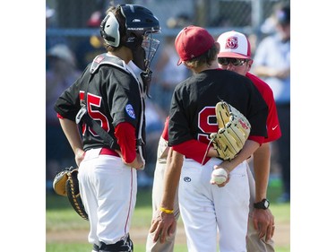 Alberta's Southwest Little league #35 Teigen Parenteau and # Riley Pearce  listen to manager Denny Puszkar during a break in play against Hastings Community Little League in a semi final game at the Canadian Little League Championships, Vancouver, August 12 2016.