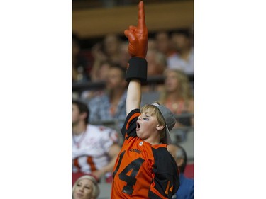 A BC Lions fans cheers after the Leos scored a touchdown against the Hamilton Tiger-Cats.