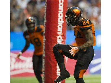BC Lions #18 Geraldo Boldewijn watches teammate #24 Jeremiah Johnson high step after his touchdown against the Hamilton Tiger-Cats.