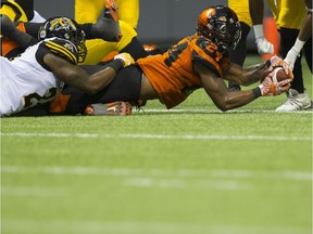 BC Lions #29 Steven Clarke dives over the goal line to score a touchdown against the Hamilton Tiger-Cats.
