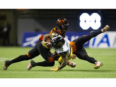 BC Lions #29 Steven Clarke tackles Hamilton Tiger-Cats  #2 Chad Owens.