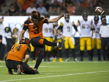BC Lions #3 Richie Leone kick set by #14 Travis Lulay  goes wide against the Hamilton Tiger-Cats.