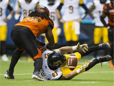 BC Lions #56 Solomon Elimimian covers Hamilton Tiger-Cats  #83 Andy Fantuz who is unable to make a catch.