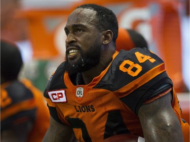 BC Lions #84 Emmanuel Arceneaux sits on the bench with the game winning ball after scoring a touchdown against the Hamilton Tiger-Cats.