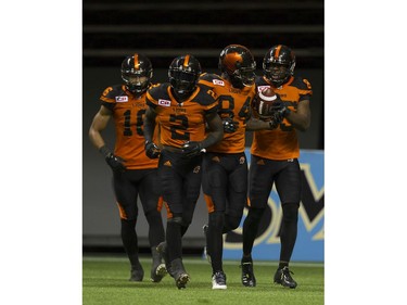 BC Lions #85 Shawn Gore, hands the game winning ball to #84 Emmanuel Arceneaux after he scored a touchdown against the Hamilton Tiger-Cats.