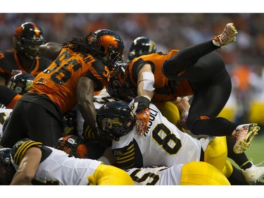The BC Lions and Hamilton Tiger-Cats pile on.