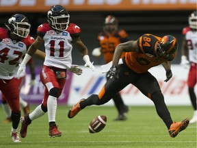 B.C. Lions receiver Emmanuel Arceneaux looks down at an incomplete pass while pursued by Calgary Stampeders Joshua Bell in in Friday's 37-9 loss at B.C. Place.