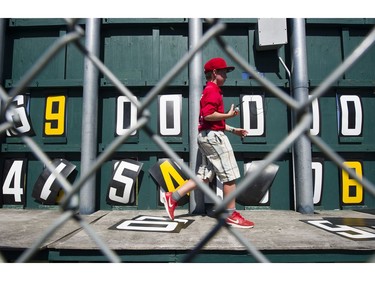 VANCOUVER August 19 2016. Henry Bull carries  a radio as he moves to change the numbers on the scoreboard for a Vancouver Canadians game at Nat Bailey stadium  Vancouver, August 19 2016. ( Gerry Kahrmann  /  PNG staff photo)  ( Prov / Sun News ) 00044657A Story by Steve \Ewen [PNG Merlin Archive]
