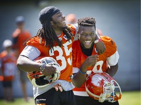 B.C. Lions Shaquille Murray-Lawrence (left) and Shaquille Johnson joke around during practice this week at the CFL team’s training facility in Surrey.