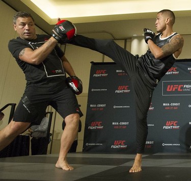 UFC fighter Anthony Pettis (right) kicks out during a brief training session/demonstration at the Hyatt Regency hotel in Vancouver on Thursday. The featherweight fighter is on the main card Saturday night against Charles Oliveira at UFC on FOX 21 at Rogers Arena.