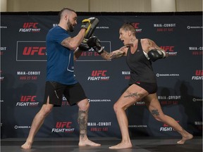 UFC fighter Bec Rawlings (right) works out with Adrian Rodriguez at the Hyatt Regency hotel in Vancouver on Thursday. Rawlings is on the main card of UFC on FOX 21 on Saturday at Rogers Arena, taking on Paige VanZant in a women’s strawweight bout.