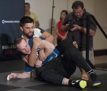 UFC fighter Carlos Condit (on top) has a hold on coach Ricky Lundell at the Hyatt Regency hotel in Vancouver on Thursday. The welterweight will face Demian Maia in the main bout of UFC on FOX 21 on Saturday at Rogers Arena.