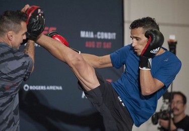 UFC fighter Charles Oliveira kicks up at trainer Jorge Patino at the Hyatt Regency hotel in Vancouver on Thursday. The featherweight fighter will face Anthony Pettis on the main card of UFC on FOX 21 at Rogers Arena on Saturday.