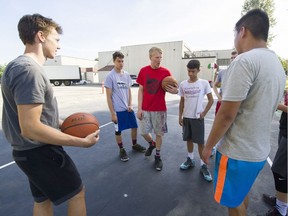 Brodan Thiel, centre in red shirt, runs Dynamite Basketball Academy in East Van. Shown on his home court outside the Italian Cultural Centre , Thiel is giving back to the community both on and off the court.