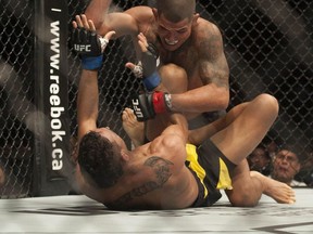 VANCOUVER, BC: AUGUST 27, 2016 -- UFC Fight Night at Rogers Arena in Vancouver, BC Saturday, August 27, 2016. Pictured is Charles Oliveira (in yellow) versus Anthony Pettis (in black and white) in the main card featherweight bout.