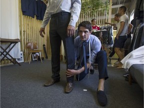 Tailor Michael Mahood, of Martin Fisher Tailors, makes adjustments to a suit worn by field hockey player Iain Smythe at his tailor shop in Vancouver. He fit members of the Canadian field hockey team for the Beijing Olympics and is doing so again for the team heading to Rio.