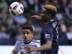 Vancouver Whitecaps midfielder Cristian Techera, left, fights for control of the ball with Sporting Kansas City defender Saad Abdul-Salaam during an MLS game in Vancouver last year. The Caps take on Sporting Saturday in K.C.