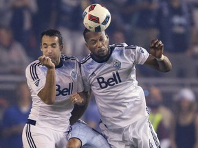 Vancouver Whitecaps midfielder Andrew Jacobson, left, and defender Kendall Waston head the ball over Sporting Kansas City's Dom Dwyer in MLS play Saturday in K.C. The teams play again at B.C. Place Tuesday in CONCACAF Champions League Kansas City at B.C. Place.