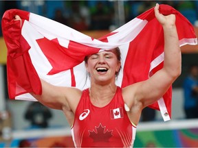 Canada's Erica Elizabeth Wiebe celebrates after winning against Kazakhstan's Guzel Manyurova in their women's 75kg freestyle final match on August 18, 2016, during the wrestling event of the Rio 2016 Olympic Games at the Carioca Arena 2 in Rio de Janeiro. /