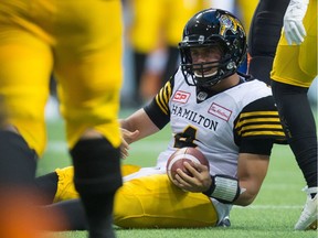 Hamilton Tiger-Cats quarterback Zach Collaros sits on the ground after being sacked on a two-point conversion attempt against the B.C. Lions during the first half of a CFL game in Vancouver on Saturday.