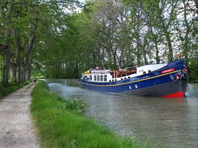 Hotel barge Anjodi cruises along 17th century Midi Canal in southern France. Mike Grenby