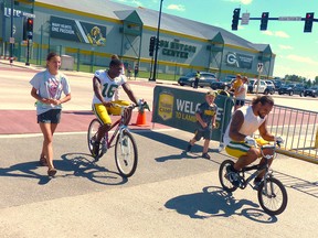 Packers players join little kids after practice to ride the kids’ bikes back to their dressing room. Michael McCarthy