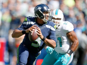 SEATTLE, WA - Seahawks quarterback Russell Wilson looks to pass against the Miami Dolphins on Sunday at CenturyLink Field.