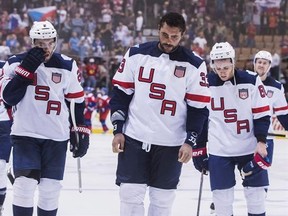 Team USA&#039;s Dustin Byfuglien, centre, Matt Niskanen, left, and Patrick Kane, right, leave the ice after their team lost to Team Czech Republic in World Cup of Hockey action in Toronto, Thursday September 22, 2016. THE CANADIAN PRESS/Mark Blinch
