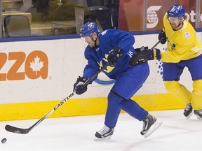 Team Sweden&#039;s Patric Hornqvist, left, and Henrik Sedin battle for a puck during a practice session at the World Cup of Hockey in Toronto on Friday, September 23, 2016. THE CANADIAN PRESS/Chris Young