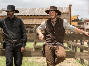 In this image released by Sony Pictures, Chris Pratt, right, and Denzel Washington appear in a scene from &ampquot;The Magnificent Seven.&ampquot; Antoine Fuqua‚Äôs ‚ÄúThe Magnificent Seven‚Äù remake rode the star power of Denzel Washington to an estimated $35 million debut, topping North American ticket sales over the weekend. (Sam Emerson/Sony Pictures via AP)