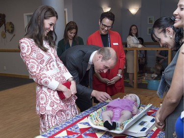 VANCOUVER, BC - SEPTEMBER 25:  Catherine, Duchess of Cambridge and Prince William, Duke of Cambridge meet a baby as she is weighed during a visit to Sheway, a charity that helps vulnerable mothers battling issues such as addiction, during their Royal Tour of Canada on September 25, 2016 in Vancouver, Canada.
