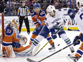 Vancouver Canucks winger Alex Grenier is stopped by Edmonton Oilers goalie Cam Talbot during an NHL game last season at Edmonton’s Rexall Place.