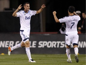 Vancouver Whitecaps midfielder Andrew Jacobson, left, celebrates his goal against the Columbus Crew with midfielder Christian Bolanos during the second half of an MLS soccer match in Columbus, Ohio, Saturday, Sept. 10, 2016. Vancouver won 3-1.