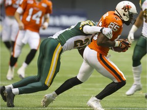 AUGUST 6,  2015. BC Lions Shawn Gore battles Edmonton Eskimos in CFL action at BC Place  in Vancouver, B.C. on August 6, 2015.  (Steve Bosch  /  PNG staff photo)  00037665B  [PNG Merlin Archive]