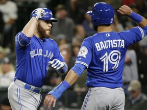 Toronto Blue Jays' Russell Martin, left, is greeted at the plate by Jose Bautista, right, after Martin's two-run home run.