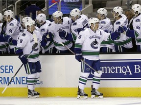 Vancouver Canucks center Bo Horvat (53) celebrates with teammates after scoring against the San Jose Sharks during the first period of an NHL preseason hockey game Tuesday, Sept. 27, 2016, in San Jose, Calif.