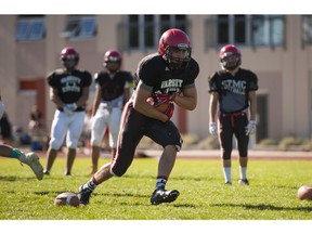 Tyler Eckert of the St. Thomas More Knights runs with the ball during practice in Burnaby Tuesday.