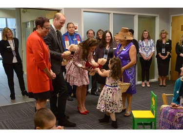 Prince William the Duke of Cambridge and Catherine the Duchess of Cambridge, receive teddy bears from five-year-old Hailey Cain during a tour of Sheway, a centre that provides support for native women,  in Vancouver, British Columbia on September 25, 2016.  /