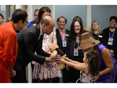 Prince William the Duke of Cambridge and Catherine the Duchess of Cambridge, receive teddy bears from five-year-old Hailey Cain during a tour of Sheway, a centre that provides support for native women,  in Vancouver, British Columbia on September 25, 2016.  /