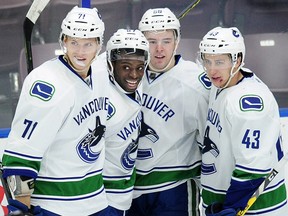 Canucks' Jordan Subban (67) celebrates his goal against the Calgary Flames with Mackenzie Stewart (71) Michael Carcone (58) and Curtis Valk (43). (Nick Procaylo/PNG)
